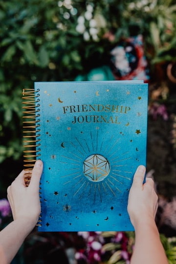 A child holding the Friendship Journal